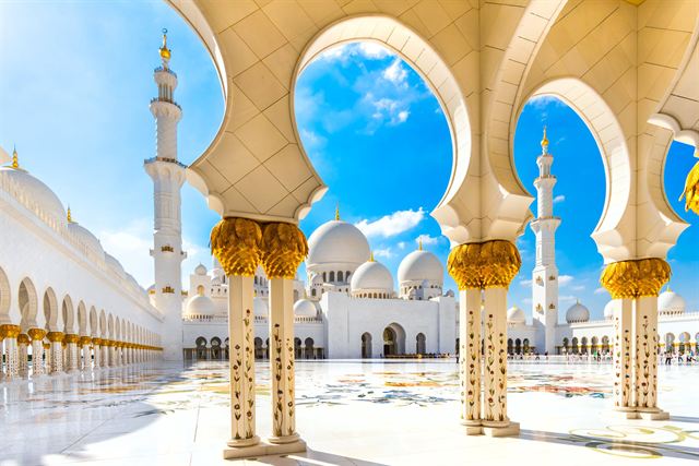 White marble arcades with golden palm columns at Sheikh Zayed Grand Mosque, Abu Dhabi