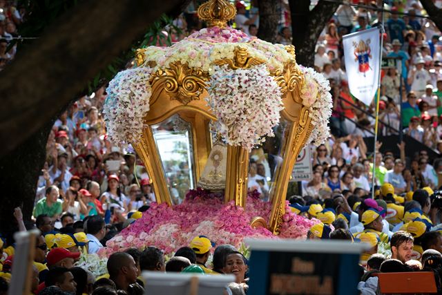 Crowds around the flower-covered statue of Our Lady of Nazareth during the Círio de Nazaré in Belém