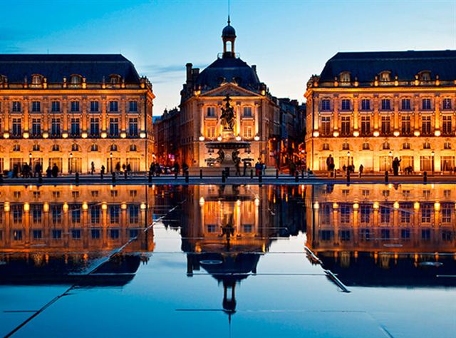 Place de la Bourse lit at dusk and reflected in the Miroir d'Eau in Bordeaux