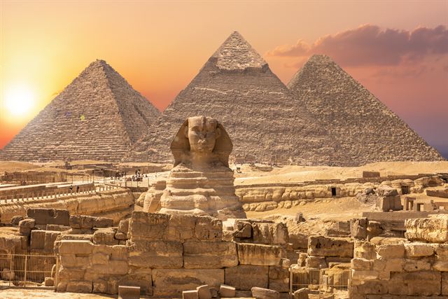 Great Sphinx and the Pyramids of Giza at sunset on the edge of Cairo
