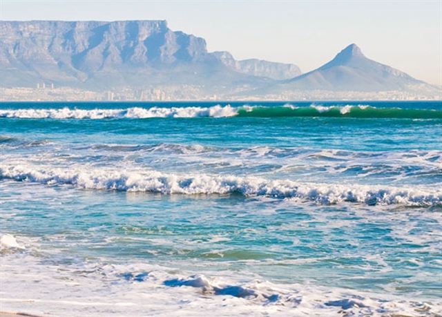 Table Mountain and Lion's Head across Table Bay with surf in the foreground