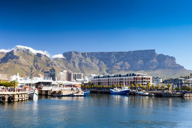 V&A Waterfront in Cape Town with Table Mountain behind under a blue sky