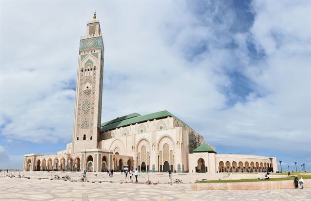 Hassan II Mosque with its tall decorated minaret and green-tiled roofs on the Casablanca waterfront