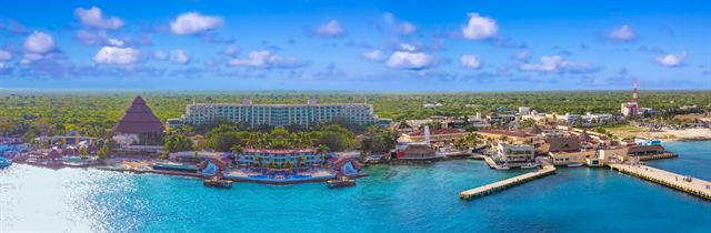 Panorama of the Puerta Maya cruise port coastline, piers and blue Caribbean water in Cozumel