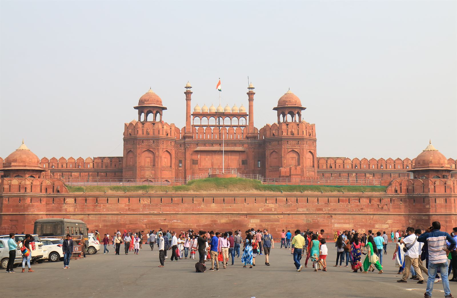 Red sandstone Lahori Gate of the Red Fort in Delhi with crowds of visitors in front