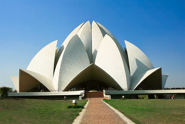 White petal-shaped Lotus Temple in Delhi with its long approach walkway and lawns