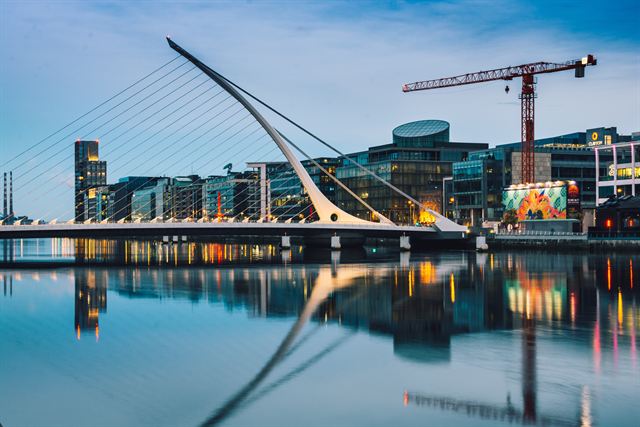 Samuel Beckett Bridge and Docklands buildings reflected in the River Liffey