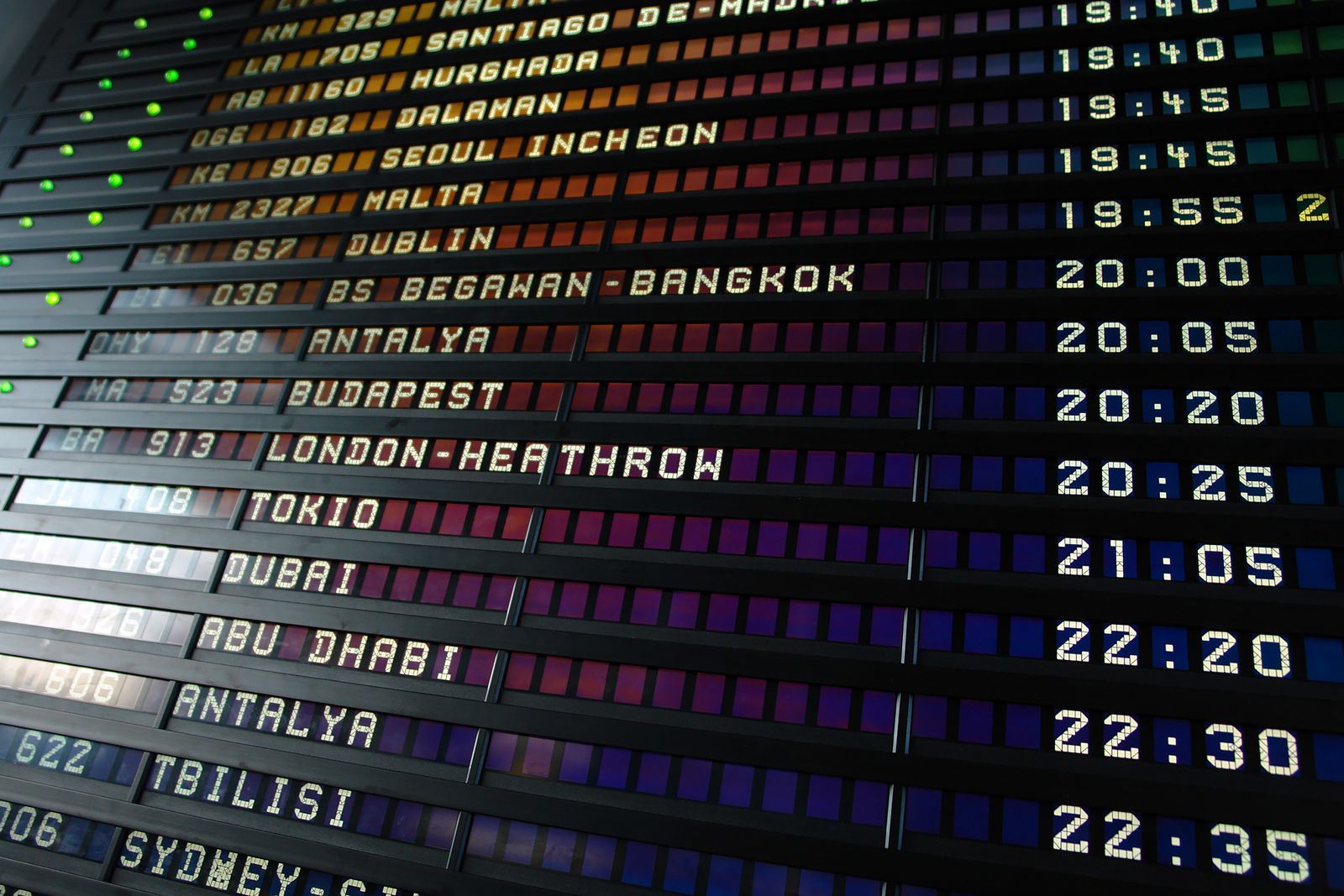 Airport departure board listing international flights to Dublin, London Heathrow, Tokyo, Dubai and Abu Dhabi