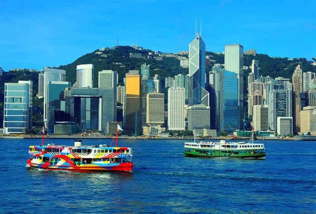 Ferries crossing Victoria Harbour in front of the Hong Kong Island skyline