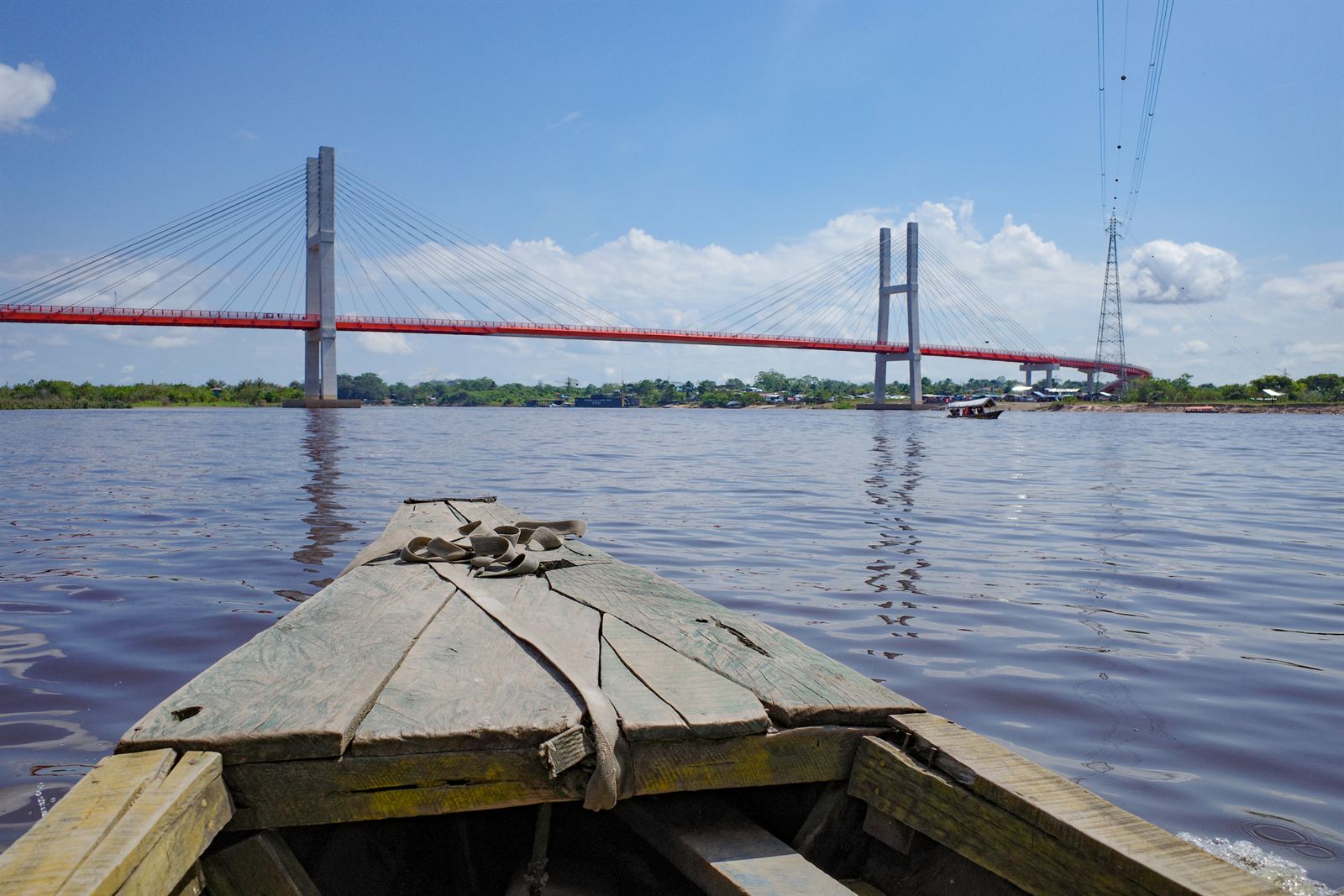Cable-stayed Nanay River bridge seen from a wooden boat on the Amazon near Iquitos