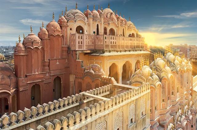 Pink sandstone domes and latticed balconies atop the Hawa Mahal palace in Jaipur