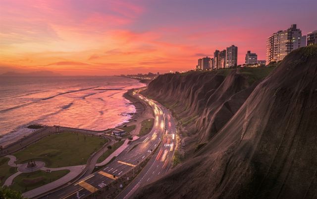 Miraflores clifftops and the Costa Verde coastal highway above the Pacific at sunset, Lima