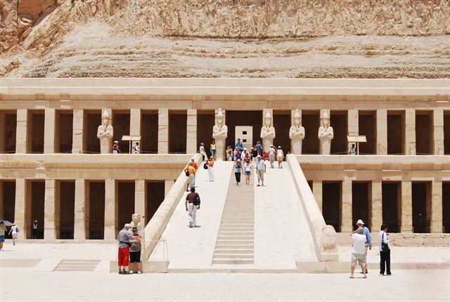 Terraced Temple of Hatshepsut with Osiride statues and tourists on the ramp near Luxor
