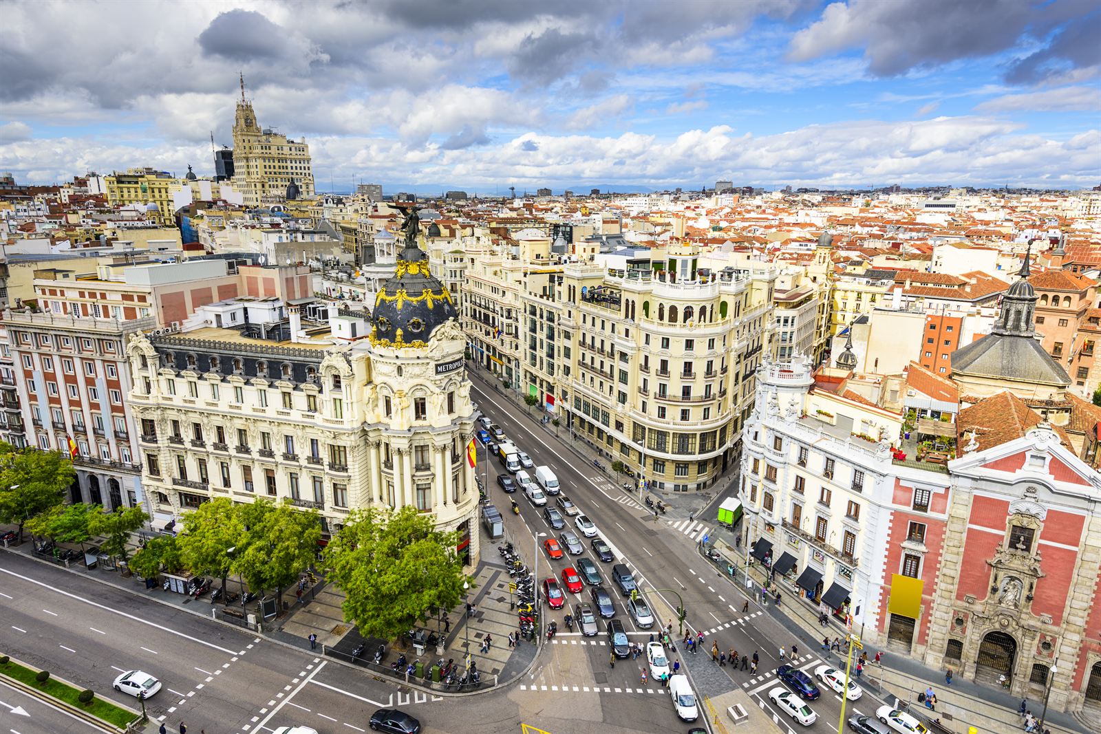 Aerial view of Madrid Gran Via with the domed Metropolis Building and busy boulevard traffic