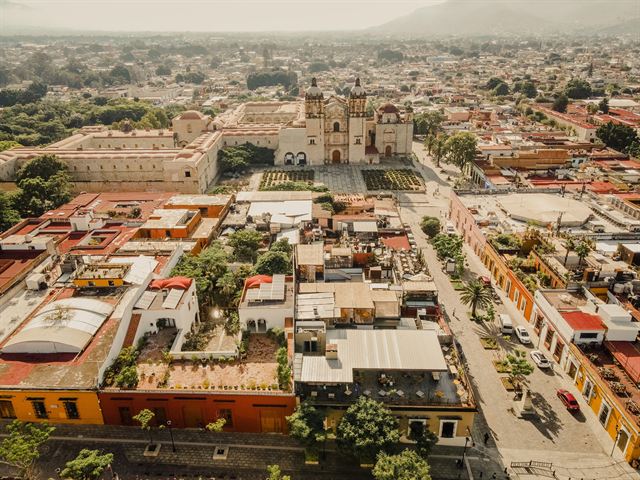 Aerial view of Oaxaca City's colonial center with the Santo Domingo church and convent amid low rooftops
