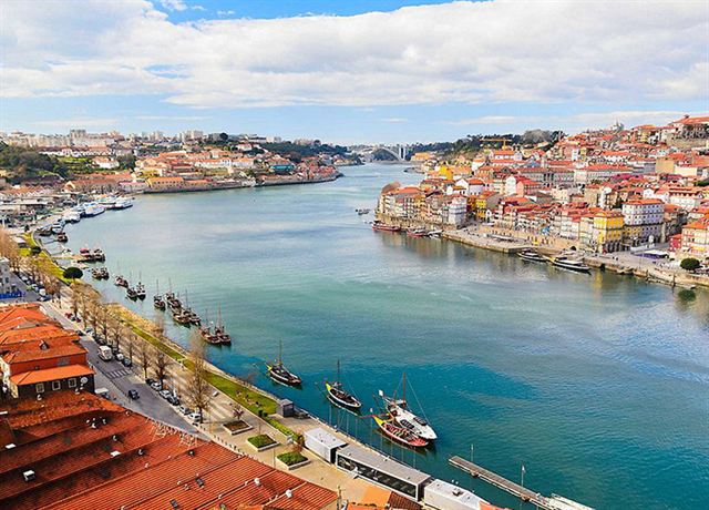 Porto Ribeira waterfront and colorful houses along the Douro river on a sunny day