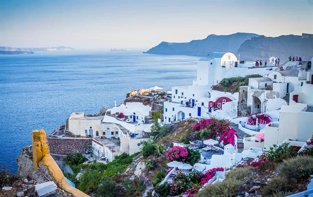 Whitewashed houses and bougainvillea on the Santorini caldera cliffs