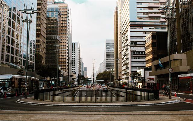 Avenida Paulista in Sao Paulo lined with modern high-rise office towers and a broad traffic plaza
