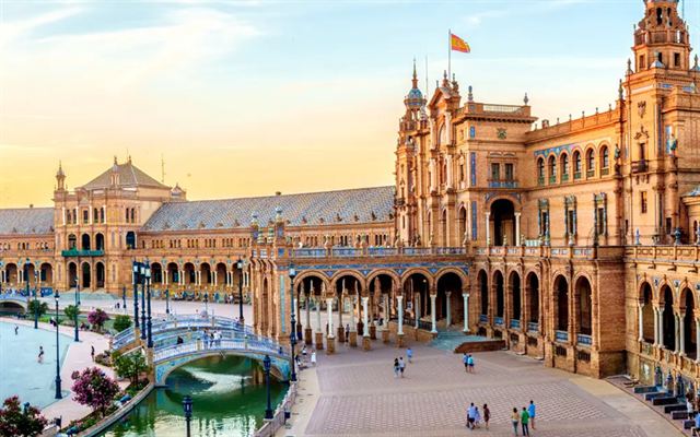 Plaza de Espana in Seville with its brick palace, towers, canal and tiled bridges