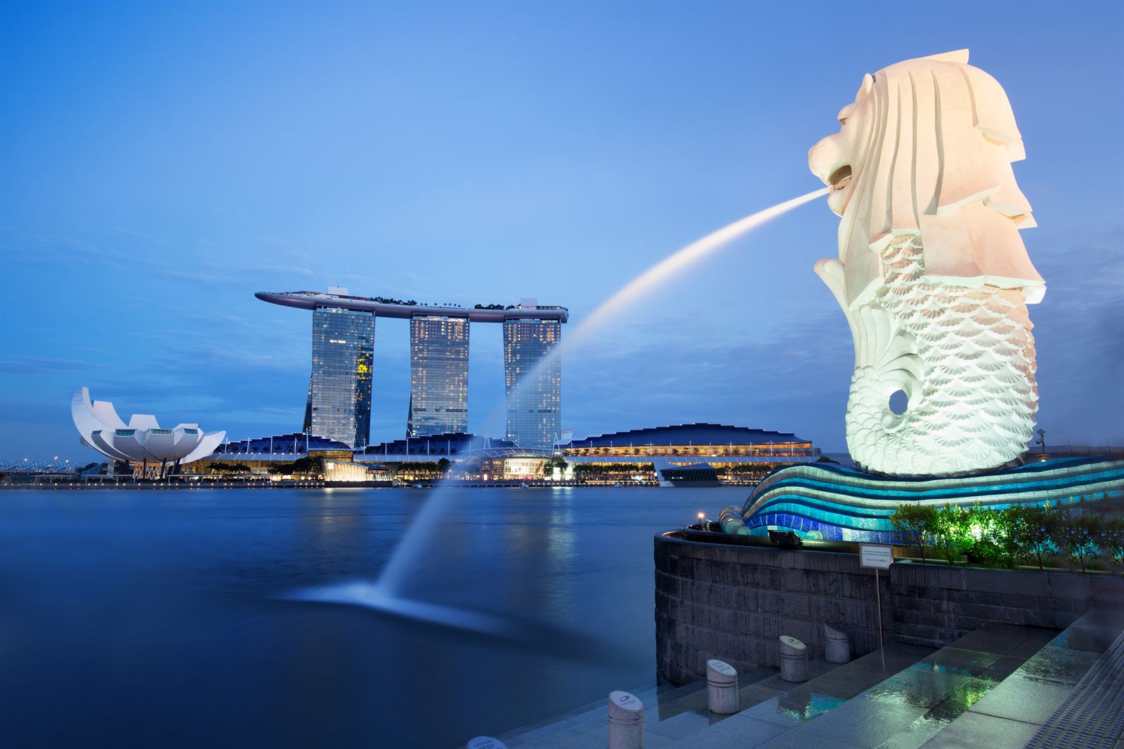 Merlion fountain spouting into Marina Bay with Marina Bay Sands behind