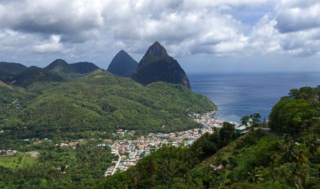 The twin Pitons rising above Soufriere town and its bay on Saint Lucia's green west coast