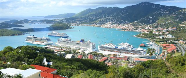 Panorama of Charlotte Amalie harbour with cruise ships, green hills and red-roofed town, St. Thomas