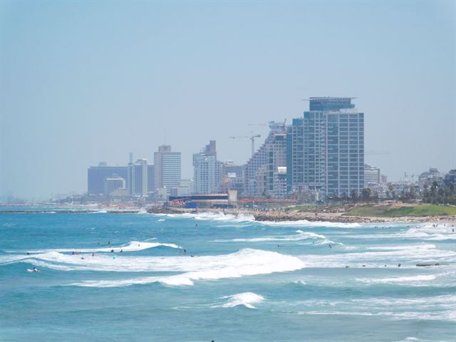 Aerial view of Tel Aviv high-rises, a seaside park and the Mediterranean shoreline